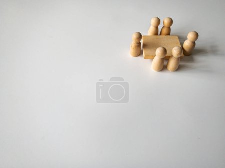 Photo for Wooden people figures having business meeting with customizable space for text. Meeting concept and copy space. - Royalty Free Image