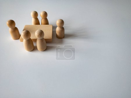 Photo for Wooden people figures having business meeting with customizable space for text. Business concept and copy space - Royalty Free Image