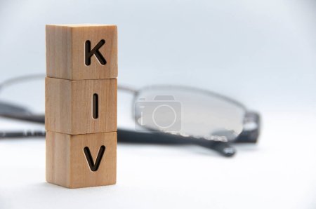 Photo for KIV text engraved on wooden blocks with white cover background. Keep in view concept. Copy space. - Royalty Free Image