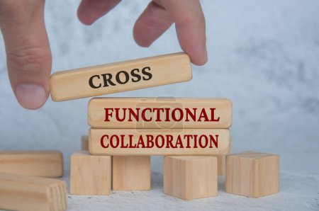 Photo for Hand placing wooden blocks with cross functional collaboration text on wooden blocks. Operational excellence and business concept. - Royalty Free Image