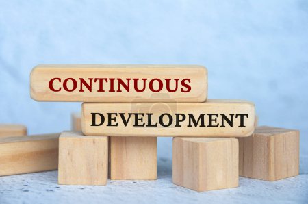 Photo for Continuous development text on wooden blocks with blur cover background. Operational excellence concept. - Royalty Free Image