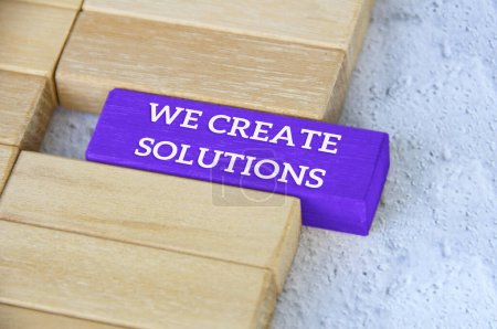 Photo for Top view of text - we create solutions text on blue wooden block separated from the rest of the blocks. - Royalty Free Image