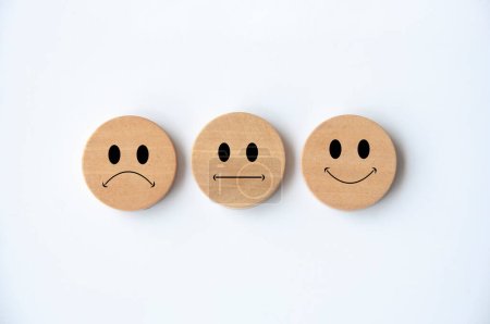 Caras emoticones felices, tristes y neutrales en círculo de madera con cubierta de fondo blanco. Comentarios de los clientes, satisfacción y evaluación y concepto.