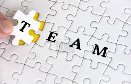 Photo for Team text on white jigsaw puzzle. Business and teamwork concept. - Royalty Free Image