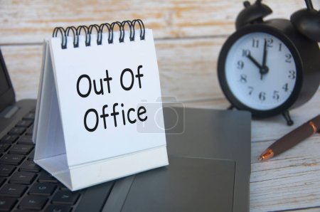 Out of office notification text on white notepad. Out of Office concept.