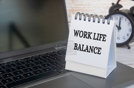 Photo for Work life balance text on table notepad with laptop background. Working culture concept. - Royalty Free Image