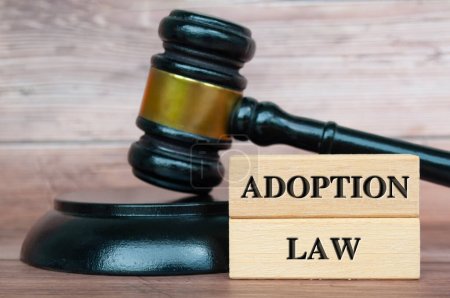 Photo for Adoption Law text engraved on wooden blocks - Royalty Free Image