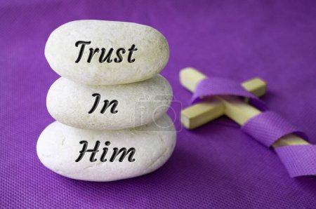 Photo for Trust in Him text on stones with Christian cross background. Prayer and Christianity concept. - Royalty Free Image