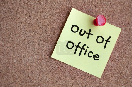 Out of office text on sticky note. Out of office concept.
