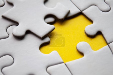 Photo for Close up view of missing jigsaw puzzle on yellow background. Copy space - Royalty Free Image