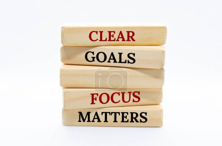 Photo for Clear goals and focus matters text on wooden blocks with white cover background. - Royalty Free Image