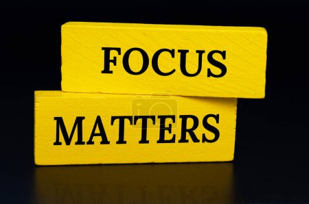 Photo for Focus matters text on yellow wooden blocks with dark cover background. Focusing concept. - Royalty Free Image