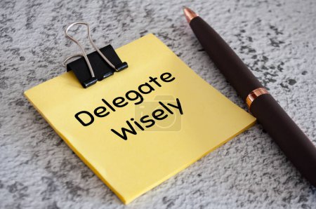 Photo for Delegate wisely text on sticky notes. Delegation of work concept. - Royalty Free Image