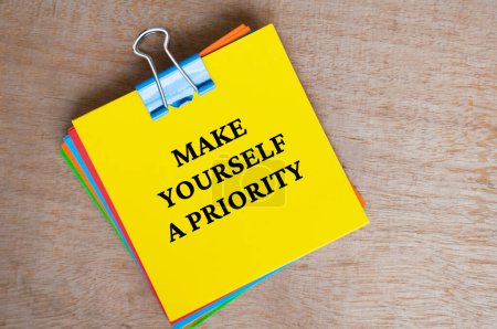 Photo for Make yourself a priority text on yellow notepad. - Royalty Free Image