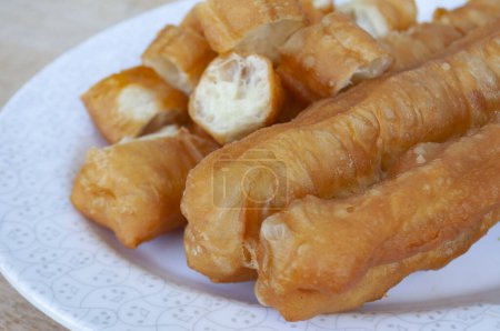 Delicious cakoi or youtiao cake on white plate. Asian food concept.