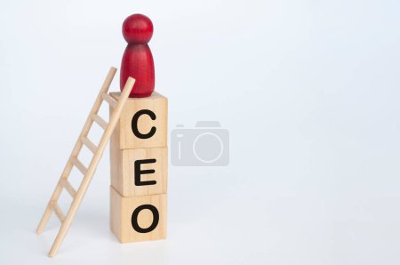 Photo for Red doll figure on top of wooden cubes with CEO text. Leadership and success concept. - Royalty Free Image