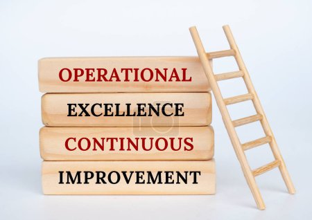 Operational Excellence and Continuous Improvement text on wooden blocks with wooden toy ladder.