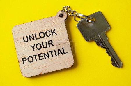 Unlock your potential text engraved on wooden key chain. Motivational concept.