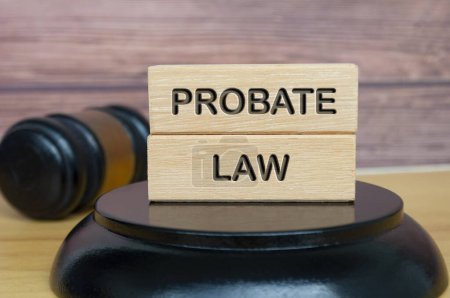 Probate law text engraved on wooden block with gavel background. Legal and law concept