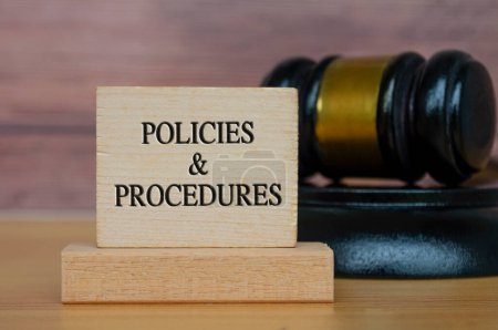 Policies and procedures text engraved on wooden block. Legal and law concept