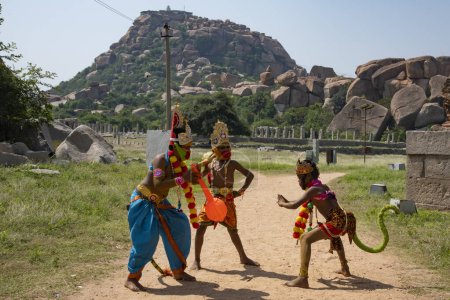 Photo for Hampi, Karnataka, India - Oct 31 2022: Children enacting scenes form the Hindu epic Ramayana at Hampi. Anjeneri Anjanadri near Hampi is believed to be the birthplace for Lord Hanumana - Royalty Free Image