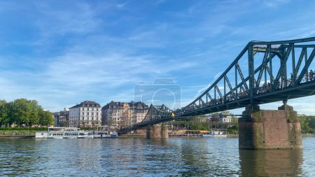 Photo for Eiserner Steg or Iron Footbridge, a footbridge spanning the river Main in the city of Frankfurt, Germany, which connects the center of Frankfurt with the district of Sachsenhausen - Royalty Free Image