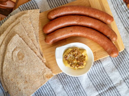 Photo for Virstli, transylvanian sausages on a wooden board with mustard - Royalty Free Image