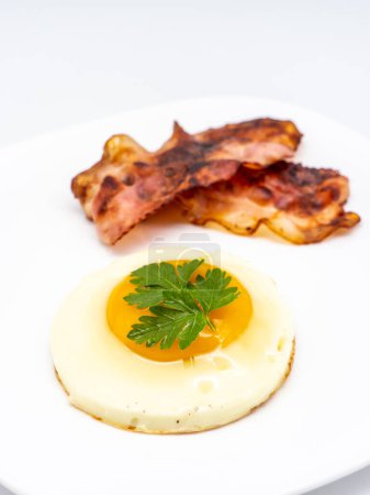 Photo for Fried eggs with bacon on white plate - Royalty Free Image