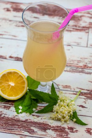 Photo for Romanian socata, summer drink made of elderberry flower, honey or sugar and aromatic plants as lemongrass and mint - Royalty Free Image