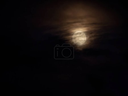 Photo for Spooky yellowish full moon and dark clouds - Royalty Free Image