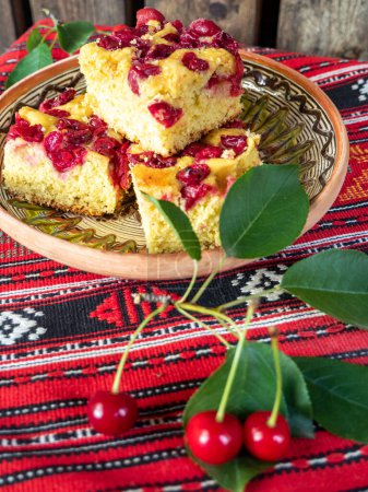 Photo for Homemade sour cherry sponge cake slices on a traditional setup - Royalty Free Image