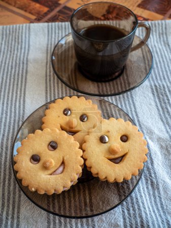 Photo for Cup of coffee with funny looking cookies, breakfast concept - Royalty Free Image