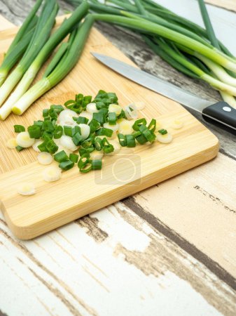 Photo for Top view of green onion cut on a cutting board - Royalty Free Image
