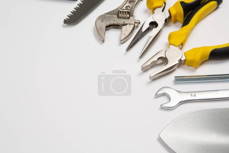 Foto de Conjunto de herramientas para la reparación en una caja sobre un fondo blanco. Surtido de herramientas de trabajo o construcción. Llaves, tenazas, destornillador. Vista superior - Imagen libre de derechos