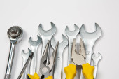 Set of tools for repair in a case on a white background. Assorted work or construction tools. Wrenches, Pliers, screwdriver. Top view Poster #651275118