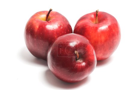 Three fresh organic red apple delicious fruit side view isolated on white background clipping path