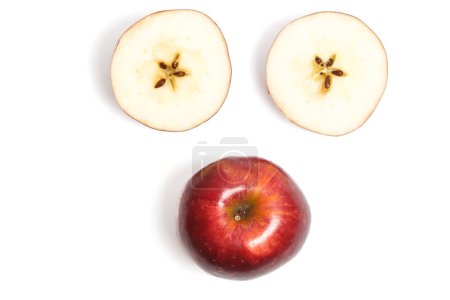 Sliced and whole fresh organic red apple delicious fruit top view face photo concept isolated on white background clipping path