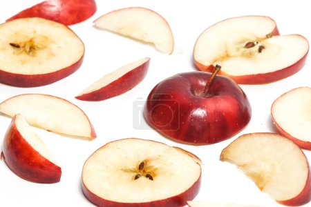 Close-up half cut sliced fresh organic red apple delicious fruit side view isolated on white background clipping path