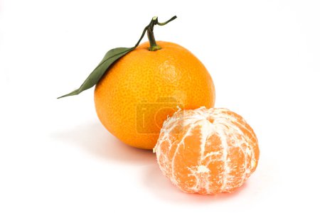 Photo for Peeled and whole fresh organic orange delicious fruit side view with green leaves isolated on white background clipping path - Royalty Free Image