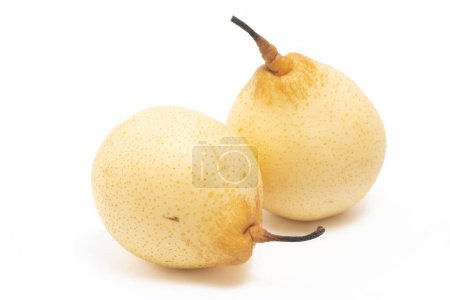 Two fresh organic yellow pear delicious fruit side view isolated on white background clipping path