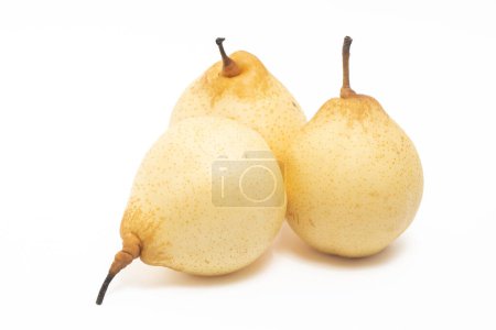 Three fresh organic yellow pear delicious fruit side view isolated on white background clipping path