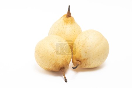Three fresh organic yellow pear delicious fruit side view isolated on white background clipping path