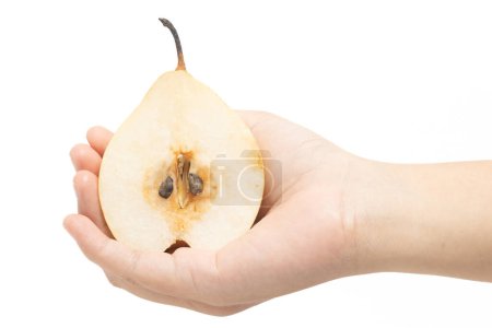 Hand holding half cut fresh organic yellow pear delicious fruit isolated on white background clipping path