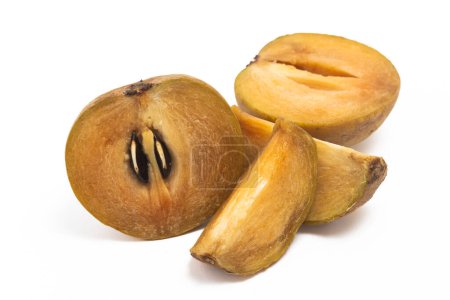 Half cut sliced fresh organic sapodilla delicious fruit isolated on white background clipping path