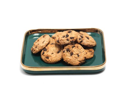 Group of chocolate chip cookies in a green plate isolated on white background clipping path