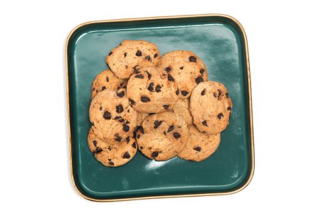 Group of chocolate chip cookies in a green plate top view isolated on white background clipping path