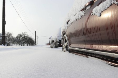 Photo for Snow calamity.  Snowy country road and parked cars. Impassable snowy road. - Royalty Free Image