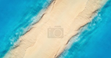 Photo for Aerial view of transparent blue sea with waves on the both sides and empty sandy beach at sunset. Top view of sandbank. Summer travel in Zanzibar, Africa. Tropical landscape with white sand and ocean - Royalty Free Image