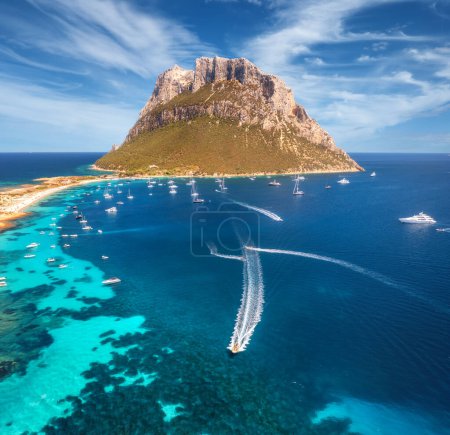 Photo for Aerial view of luxury yachts and boats on blue sea, beautiful mountain and sky with clouds at summer sunny day. Sandy beach on Tavolara island in Sardinia, Italy. Top view. Colorful seascape. Travel - Royalty Free Image