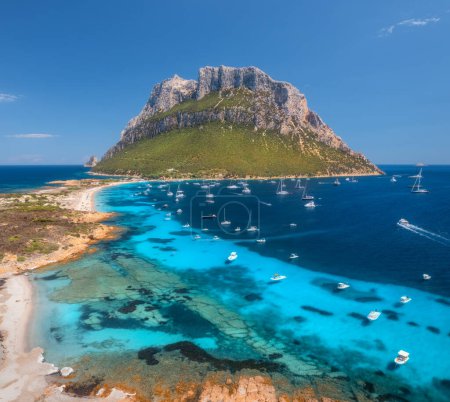 Photo for Aerial view of luxury yachts and boats on blue sea, beautiful mountain at summer sunny day. Sandy beach, rocky sea coast, turquoise water on Tavolara island in Sardinia, Italy. Top view. Seascape - Royalty Free Image